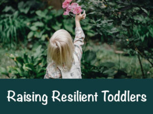 Toddler with long blonde hair reachese for roses in a bush. Raising Resilient Toddlers,