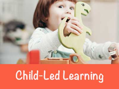 Toddler playing with dinosaur toy text reads Child-led learning